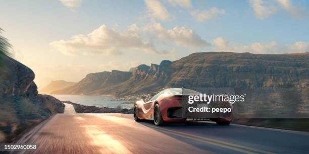 electric sports car driving along coastal road - smart car stock pictures, royalty-free photos & images