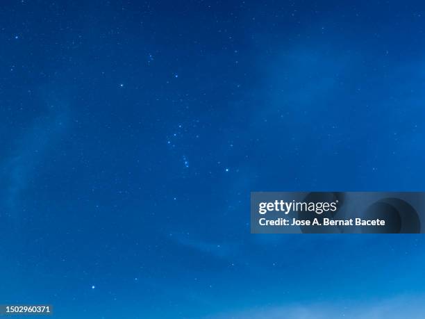 full frame of the night sky with many sparkling stars on a blue sky. - blue hour stock pictures, royalty-free photos & images