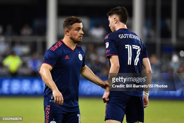 Xherdan Shaqiri of Chicago Fire has a word with team mate Brian Gutierrez during a game between Chicago Fire FC and Sporting Kansas City at...