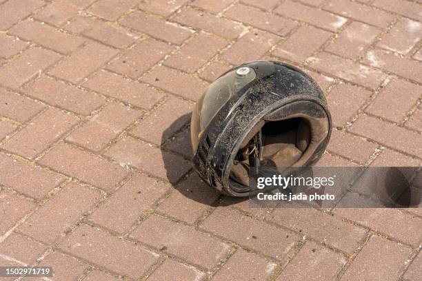 crash helmet lies on the street - motorcycle accident stock pictures, royalty-free photos & images