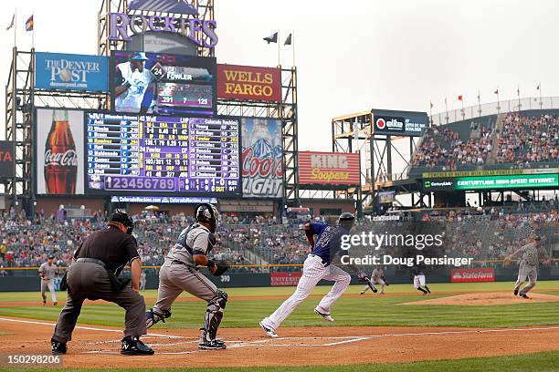 Dexter Fowler of the Colorado Rockies lays down a sacrifice bunt against Randy Wolf of the Milwaukee Brewers at Coors Field on August 14, 2012 in...