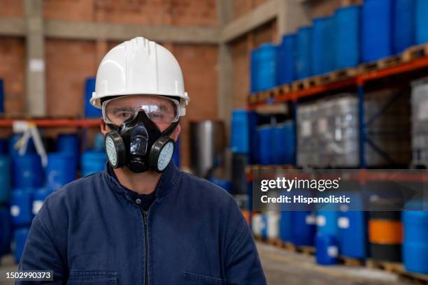 chemical plant worker wearing a gas mask and protective workwear - respirator mask stock pictures, royalty-free photos & images
