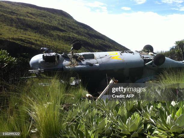 The wreckage of one of three Ugandan military helicopters sits upsidedown on August 14,2012 in Mount Kenya forest. Eight Ugandan servicemen walked...
