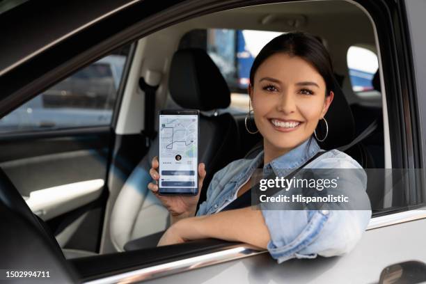 happy crowdsourced taxi driver using a mobile app - chauffeur stock pictures, royalty-free photos & images