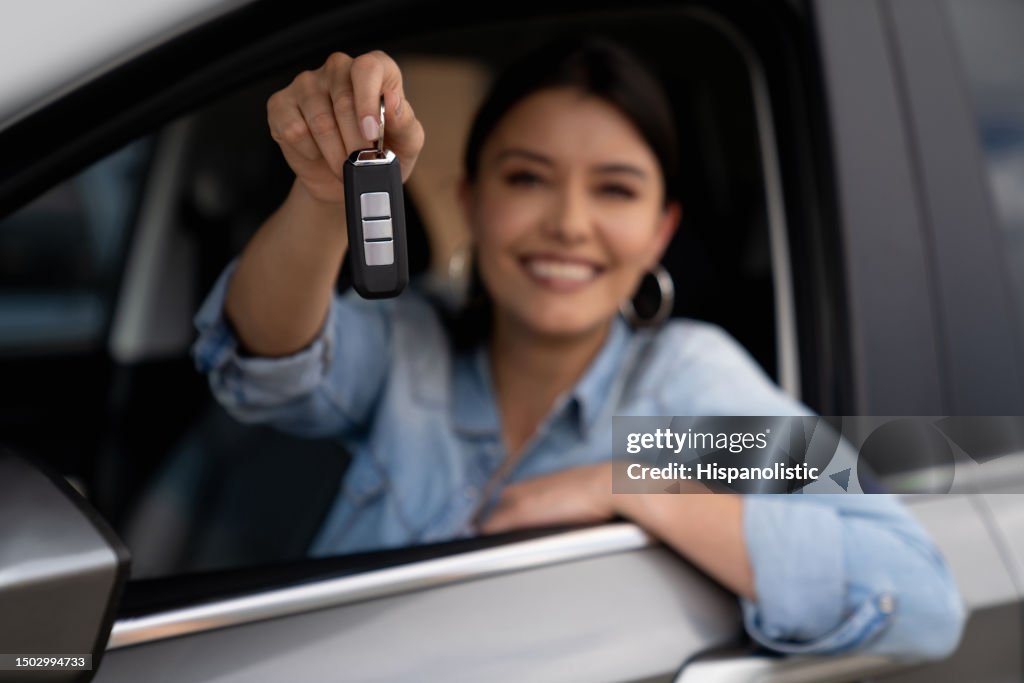 Woman holding the keys of her new car