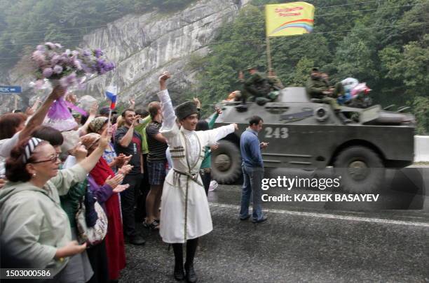 North Ossetian people celebrate as they welcome Russian soldiers as they leave South Ossetia at the North-South Ossetia border some 60 km outside...