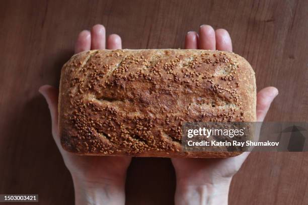 homemade rustic whole wheat bread with sesame seeds - loaf of bread stock pictures, royalty-free photos & images