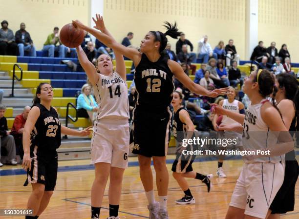 Good Counsel's Liz Gittings has her shot blocked by Paul VI's Ariana Freeman during the third period of Good Counsel's 74-48 win at Good Counsel High...