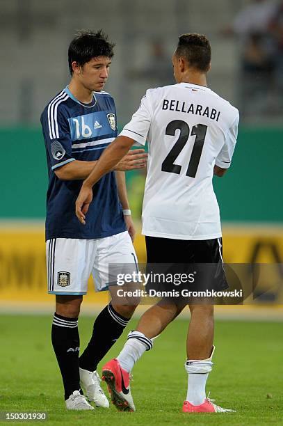 Marcos Fernandez of Argentina and Karim Bellarabi of Germany shake hands after the Under 21 international friendly match between Germany U21 and...