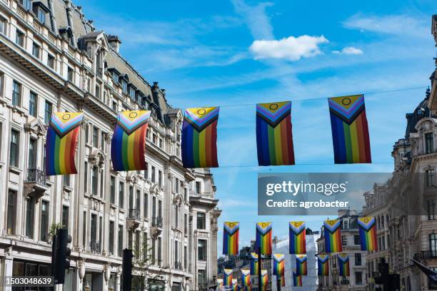 pride flags in regent street, london, uk - pride london stock pictures, royalty-free photos & images