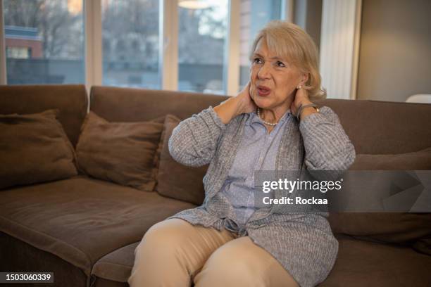 senior woman in pain - neckache stock pictures, royalty-free photos & images