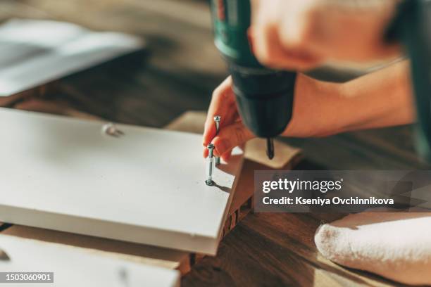 the process of furniture assembly screws closeup - cabinet stock pictures, royalty-free photos & images