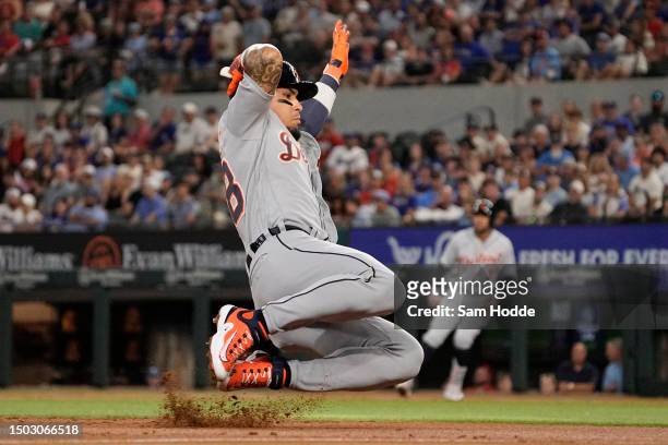 Javier Baez of the Detroit Tigers slides into third base during the second inning against the Texas Rangers at Globe Life Field on June 27, 2023 in...