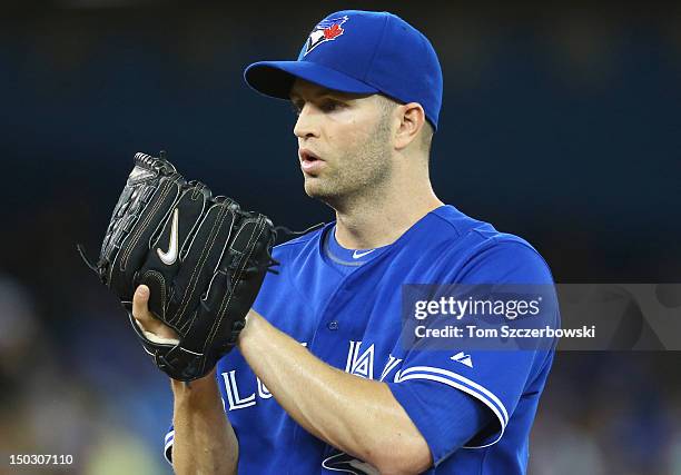 Happ of the Toronto Blue Jays looks in for the signs before delivering a pitch during MLB game action against the New York Yankees on August 12, 2012...