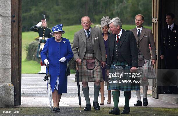 In this previously unissued file photo dated August 07 Queen Elizabeth II and Prince Edward, Earl of Wessex walk with Prince Philip, Duke of...