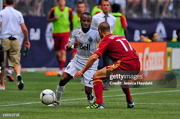 Dane Richards of the Vancouver Whitecaps brings the ball up field while being closely defended by Chris Wingert of Real Salt Lake at B.C. Place on...