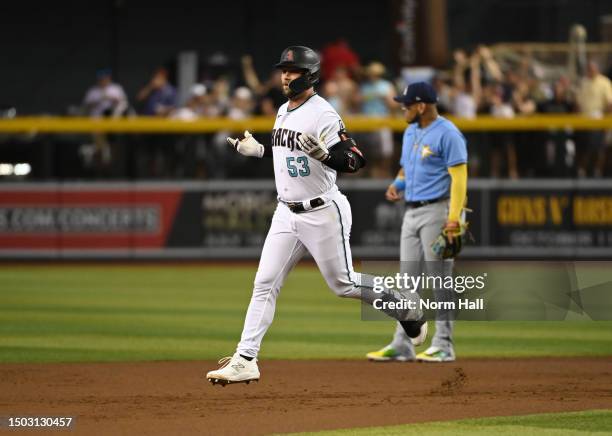 Christian Walker of the Arizona Diamondbacks gestures to the third base umpire for a ruling on his home run during the first inning against the Tampa...