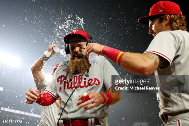 Bryson Stott and Kody Clemens of the Philadelphia Phillies celebrate with Brandon Marsh after the game against the Chicago Cubs at Wrigley Field on...