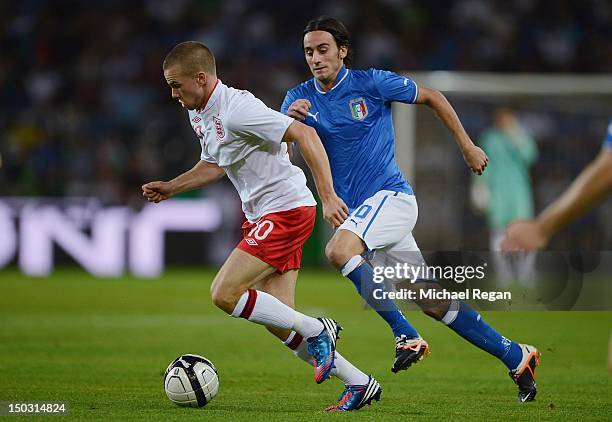 Tom Cleverley of England competes for the ball with Alberto Aquilani of Italy during the international friendly match between England and Italy at...