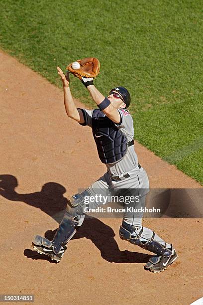 Lou Marson of the Cleveland Indians fields a ball hit by the Minnesota Twins on July 29, 2012 at Target Field in Minneapolis, Minnesota. The Twins...