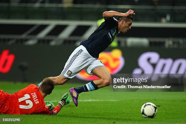 Ron-Robert Zieler of Germany fights for the ball with Jose Sosa of Argentina during the international friendly match between Germany and Argentina...