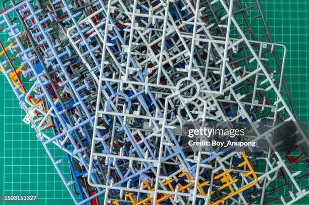 group of finished plastic model runner after assembling a plastic model toy on green cutting mat. - cutting mat stock pictures, royalty-free photos & images