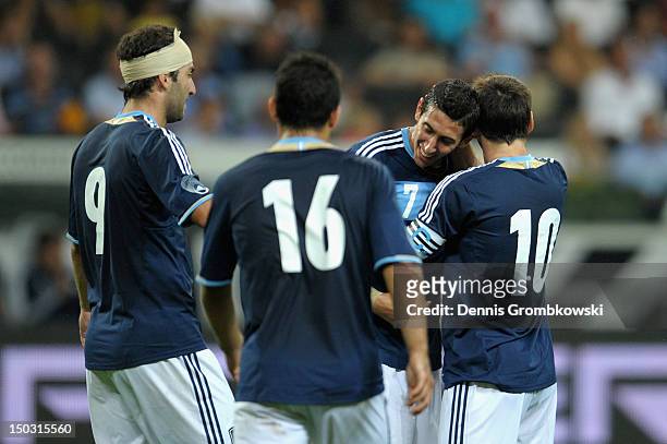 Angel di Maria of Argentina celebrates with teammates Lionel Messi, Gonzalo Higuain and Sergio Aguero after scoring his team's third goal during the...