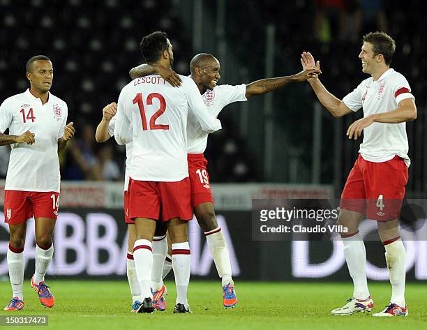 Jermain Defoe of England celebrates with Joleon Lescott and Michael Carrick after scoring their second goal during the international friendly match...