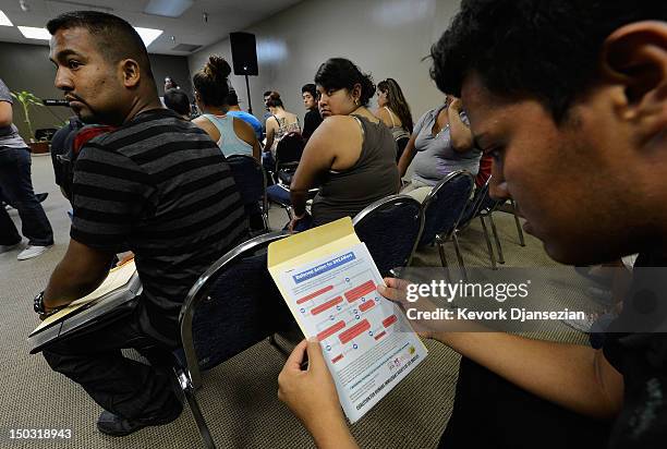 People attend an orientation class in filing up their application for Deferred Action for Childhood Arrivals program at Coalition for Humane...