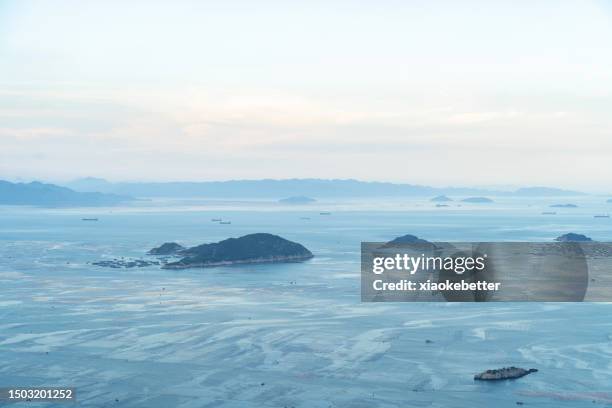 fish farms and islands on the sea surface - sea islands stock pictures, royalty-free photos & images