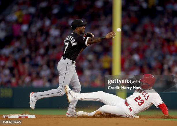 Tim Anderson of the Chicago White Sox makes a throw over Brandon Drury of the Los Angeles Angels for a double play during the fifth inning at Angel...