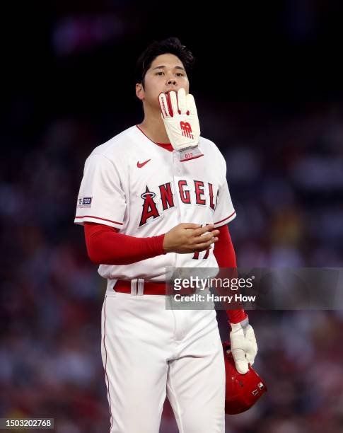 Shohei Ohtani of the Los Angeles Angels reacts on base as he waits during a timeout in the fifth inning against the Chicago White Sox at Angel...