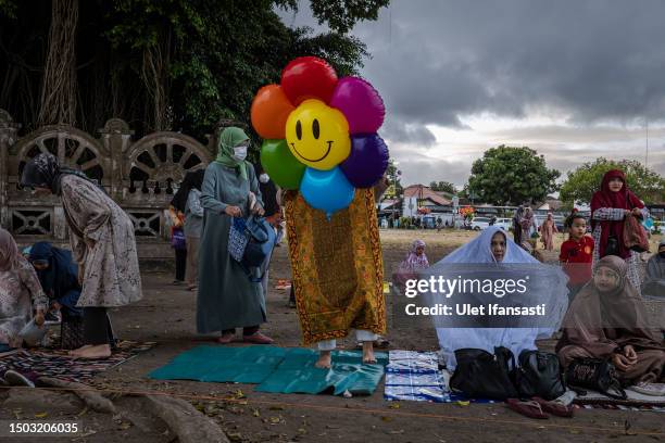 Indonesian Muslims prepare as they attend Eid al-Adha prayer at southern city square, known as 'Alun-alun kidul', on June 28, 2023 in Yogyakarta,...