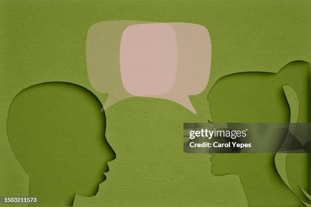 people talking with bubbles speech in felt.green background - thinking bubble stock-fotos und bilder