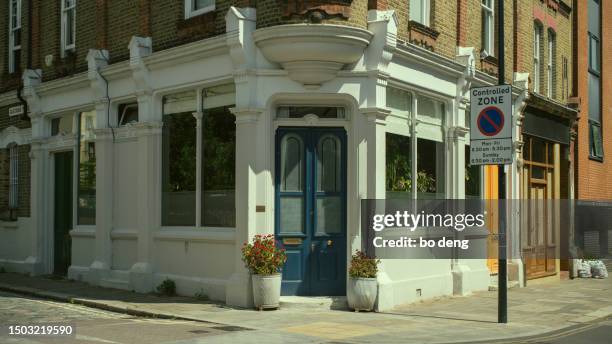 corner store with blue doors - corner shop london stock pictures, royalty-free photos & images