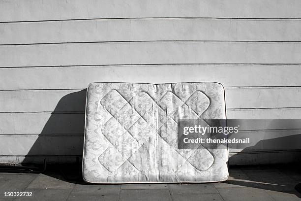 old mattress on street - matras stockfoto's en -beelden