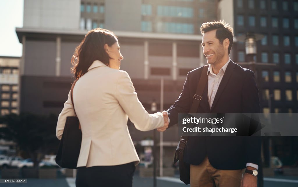 Business people, handshake and city in meeting, agreement or partnership for deal outdoors. Happy man and woman shaking hands in street for greeting, introduction or b2b and friendship in urban town