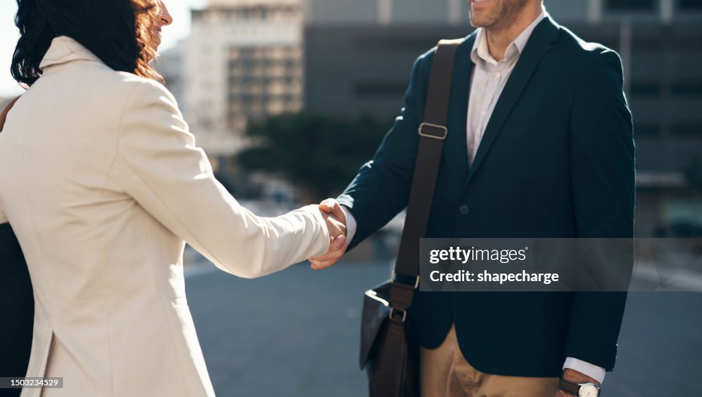 Business people, handshake and city in partnership, meeting or agreement for deal outdoors. Man and woman shaking hands in street for greeting, introduction or b2b and friendship in an urban town