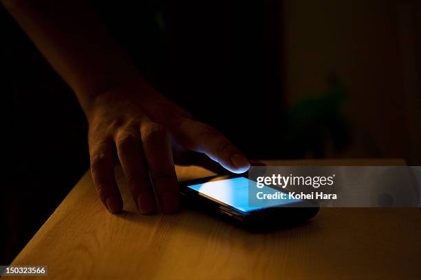 man using a cellular phone - smart phone on table stock pictures, royalty-free photos & images