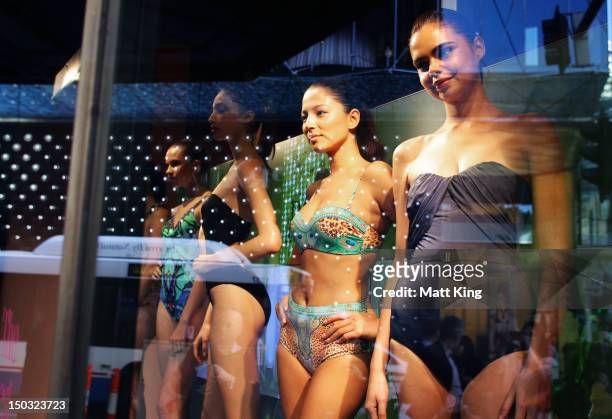 Alexandra Agoston , Jessica Gomes and Samantha Harris showcase swimwear designs at the David Jones Elizabeth Street Store on August 16, 2012 in...