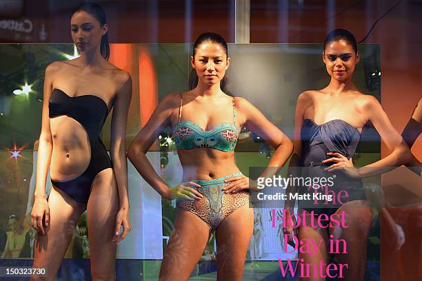 Alexandra Agoston , Jessica Gomes and Samantha Harris showcase swimwear designs at the David Jones Elizabeth Street Store on August 16, 2012 in...
