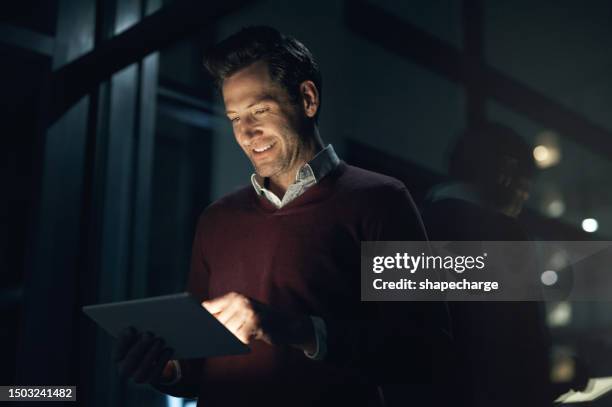 business, night and man with a tablet, connection and search internet with network, website information and typing. male person, web designer and employee check software, data update and working late - searching the web stockfoto's en -beelden