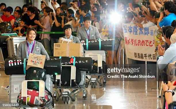 Gold medalists Kaori Icho, Hitomi Obara and Tatsuhiro Yomenitsu are welcomed upon arrival at Narita International Airport on August 14, 2012 in...