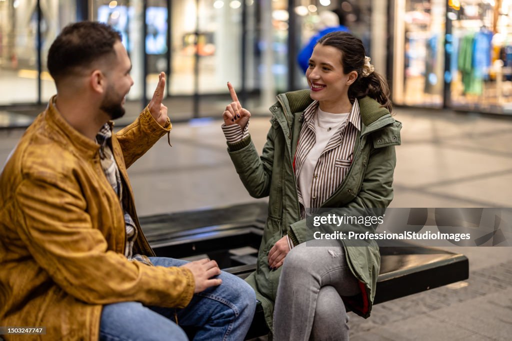 Couple In Sign Language Young Couple Using Sign Language To Express Their Feelings High-Res ...