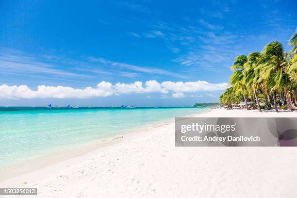 boracay island's white sand beach: pristine shoreline with crystal clear turquoise waters and palm trees. - boracay beach stock pictures, royalty-free photos & images