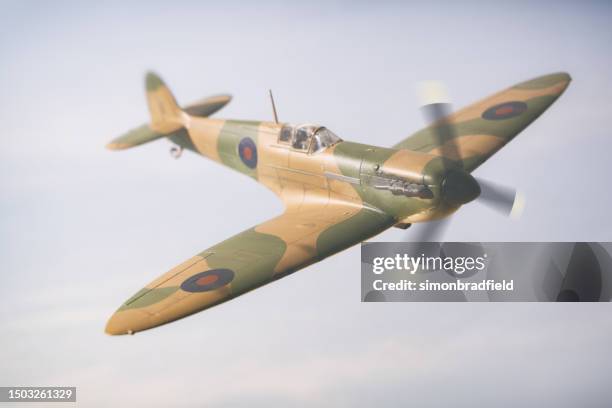 model spitfire in flight - air attack stock pictures, royalty-free photos & images