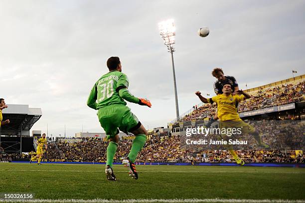 Mike Magee of the Los Angeles Galaxy and Sebastian Miranda of the Columbus Crew battle for control of the ball in front of goalkeeper Andy Gruenebaum...