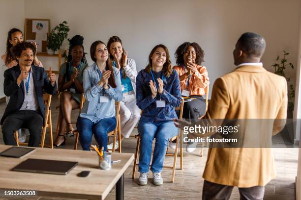 female entrepreneur holding a seminar for a group of business people - publicity event stockfoto's en -beelden