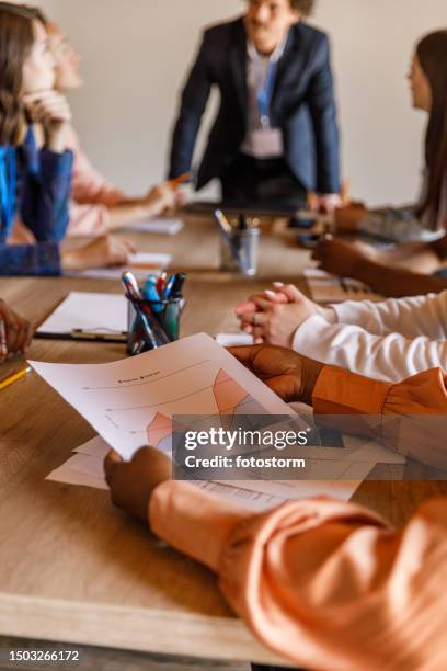 group of diverse, young business people in a project meeting around conference table - team building stock pictures, royalty-free photos & images