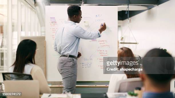 businessman, presentation or manager writing on board for teaching or speaking of our vision or ideas. black man, leadership or mentor planning a startup project or target in collaboration together - public scrutiny stock pictures, royalty-free photos & images